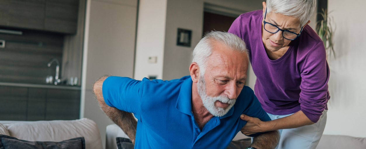 Wife helping her husband with chronic pain