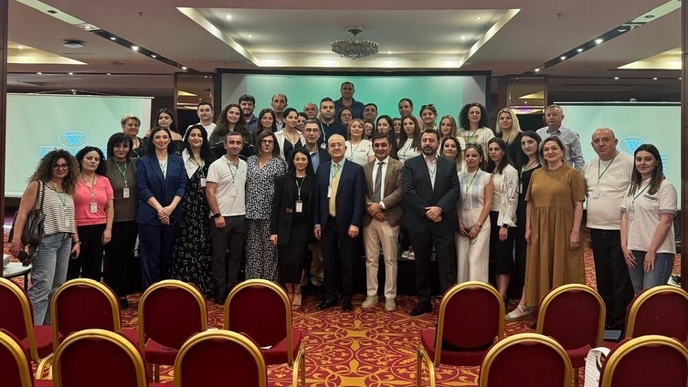 Dr. Badalian posing for a large group photo at the symposium.