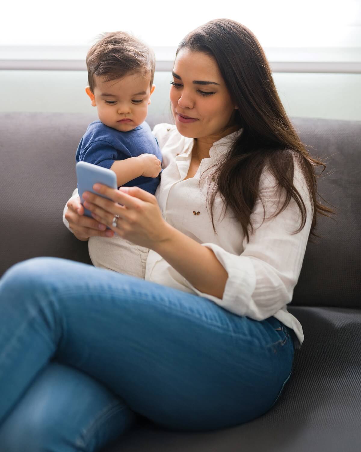 Mother using phone to look at MyBassett with son