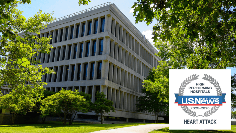 U.S. News & World Report High Performing Hosptial Seal for 2025-2026 for the Treatment of Heart Attack is seen over an image of a building on the Bassett Medical Center campus.