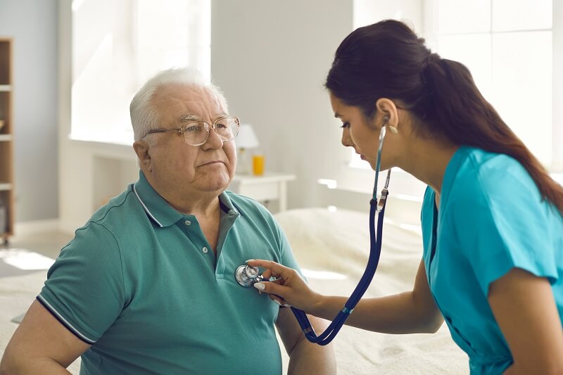 Nurse checking a patient's heartbeat after the patient experience irregular heartbeat symptoms