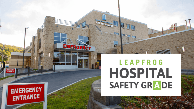 A photograph of A.O. Fox Hospital in Oneonta. On top of the photo is a seal recognizing the hospital as one that earned an "A" Leapfrog Hospital Safety Grade. 
