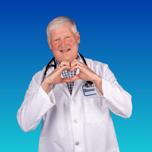 Doctor in white coat making heart shape with hands