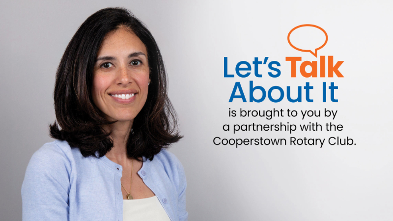A photo of Dr. Nicole Betancourt, a woman with shoulder length hair, is next to text that reads "Let's Talk About It is brought to you by a partnership with the Cooperstown Rotary Club"