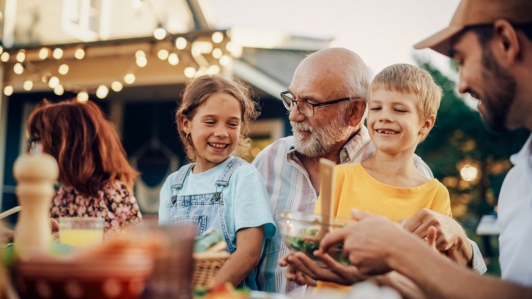 Senior man with grandchildren at a BBQ