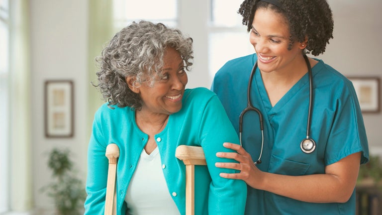 senior woman getting care from nurse