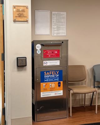 A silver metallic collection kiosk in a seating area