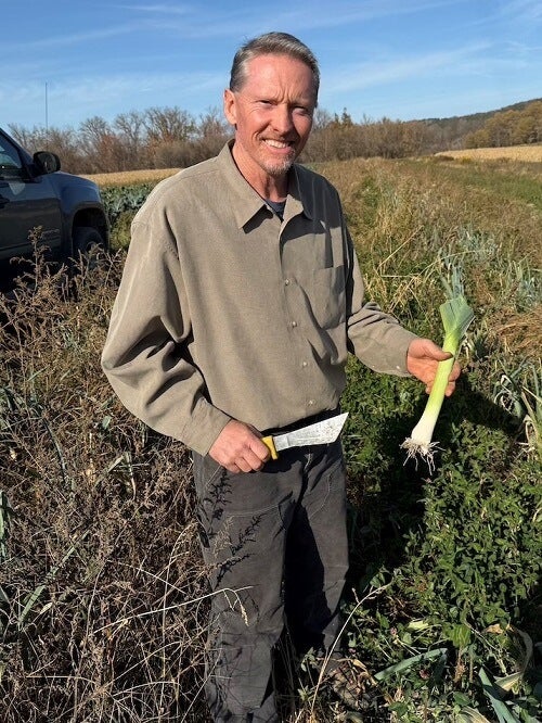 Ethan Ball of Schoharie Valley Farms, harvesting leeks